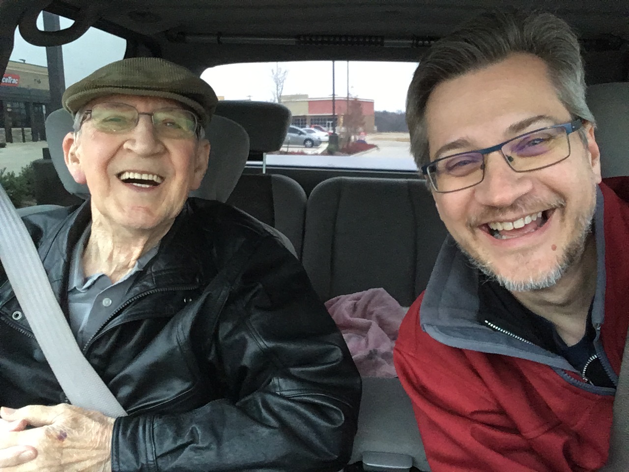 Tim Ristow laughing with his father, Leonard Ristow, Jr., in the car