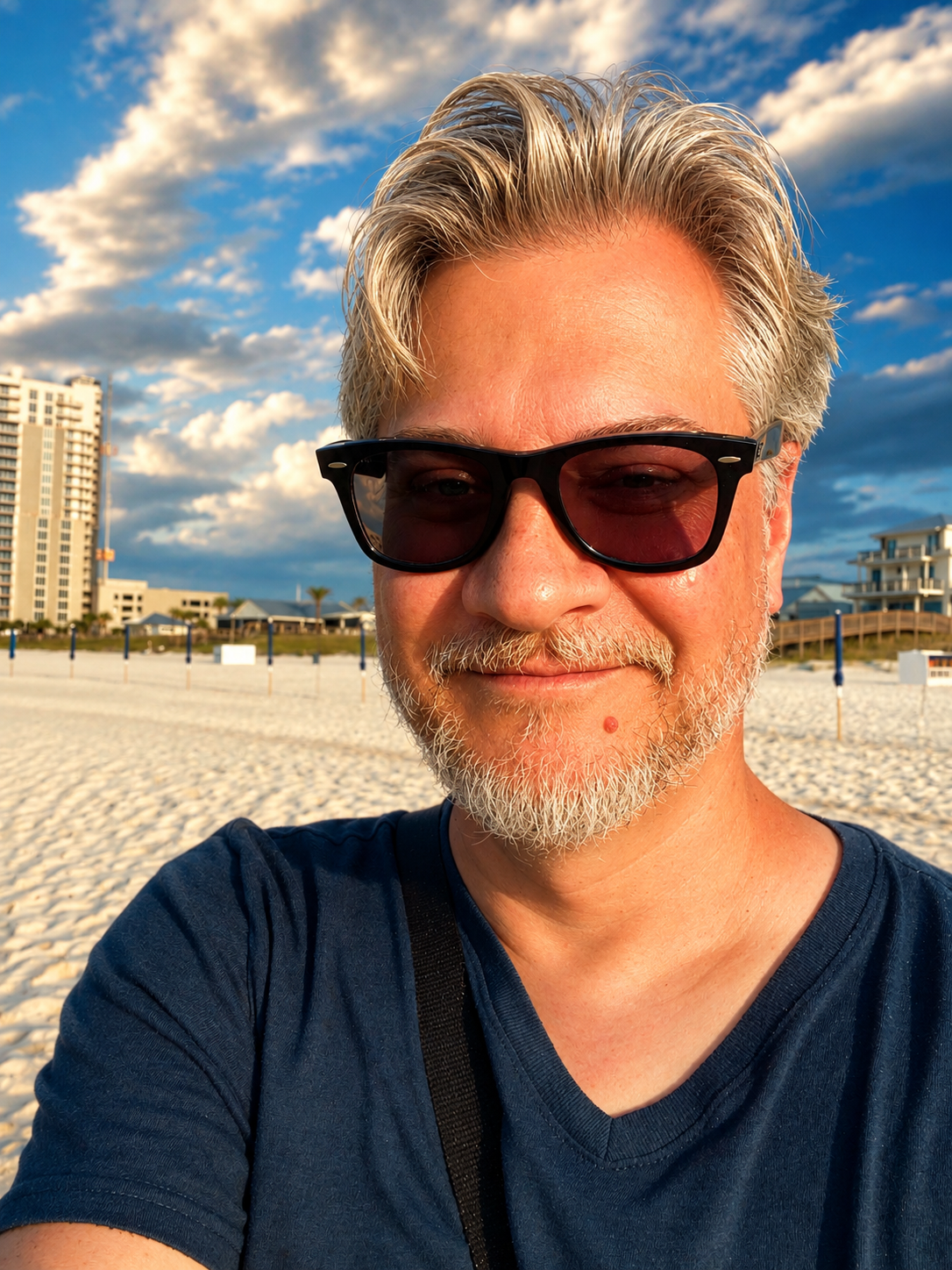 Tim Ristow in sunglasses on a Gulf Coast beach at golden hour